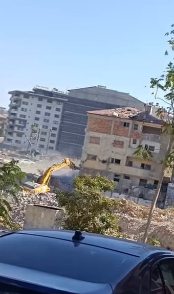 Yıktığı binanın altında kalmaktan saniyelerle kurtuldu, korku dolu anlar kamerada (Fotoğraflı) Ramazan İlın - Arzu Kübra Doğan HATAY (İHA) - Hatay’ın Defne ilçesinde 5 katlı binanın yıkımının gerçekleştiği esnada iş makinesinin, yıktığı binanın altında kalmaktan saniyelerle kurtulduğu anlar kameraya yansıdı. Kahramanmaraş merkezli depremlerde büyük yıkımın yaşandığı Hatay’da mahkeme süreci tamamlanan binalar yıkılmaya devam ediyor. Depremin vurduğu Defne ilçesi Sümerler Mahallesi’nde mahkeme süreci tamamlanan 5 katlı bina, iş makinesinin darbesiyle kontrollü olarak yıkıldı. 5 katlı binanın kontrollü olarak yıkan operatörün binanın altında kalmaktan saniyelerle kurtulduğu anlar cep telefonu kamerasıyla saniye saniye görüntülendi. Görüntülerde; iş makinesinin boomun yıktığı binanın altından son anda kurtulduğu ve kontrollü yıkım anları kameraya yansıdı. 5 katlı binanın kontrollü yıkılma sırasında herhangi bir olumsuzluk yaşanmadı. "Yıkımı yapan operatör, iş makinesinin boomunu son anda kurtarmayı başardı" İş makinesinin yıkım sırasından son anda altında kalmaktan kurtulduğunu ifade eden Azad Gökalp, "5 katlı binayı eksvalatör yardımıyla güvenli bir şekilde yıkımı gerçekleşti. Yıkımı yapan operatör, iş makinesinin boomunu son anda kurtarmayı başardı. Güzel bir yıkım yapıldı. O makine binanın altından kalmaktan zor kurtuldu. Operatörde sorun olmadı. Binanın tamamı düşerken operatör boomu sağ tarafa çekerek iş makinesini kurtardı" ifadelerini kullandı.