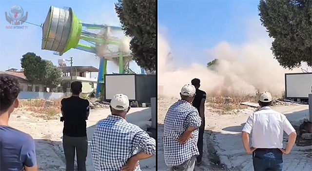 Depremde hasar gören su deposu iş makinesinin darbesiyle yıkıldı