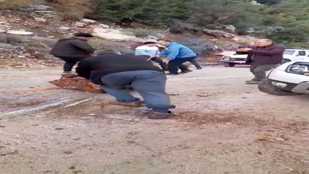 Yola düşen kayaları iple araca bağlayıp çektiler