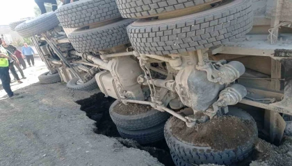 Yolun çökmesiyle kum yüklü kamyon devrildi