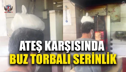 Dönerci ustası kavurucu sıcakta, ateş karşısında kafasına buz torbası koyarak serinlemeye çalıştı