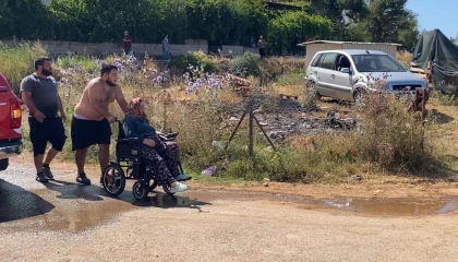 Evine yaklaşan alevlerden kurtarılan kadın tekerlekli sandalyeyle bölgeden uzaklaştırıldı