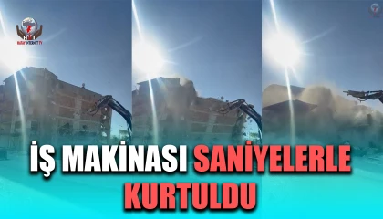 İş makinası, üzerine doğru yıkılan 6 katlı binanın altında kalmaktan saniyelerle kurtuldu