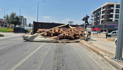 Kamyon kavşağa girerken devrildi, tomruklar yola savruldu