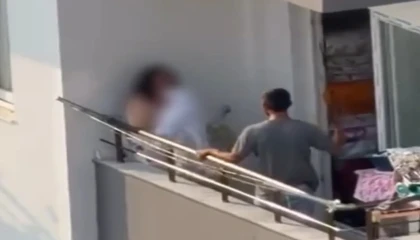 Kadını balkonda sopa ile darp etti